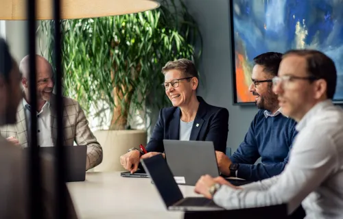 three people sitting in a conference room