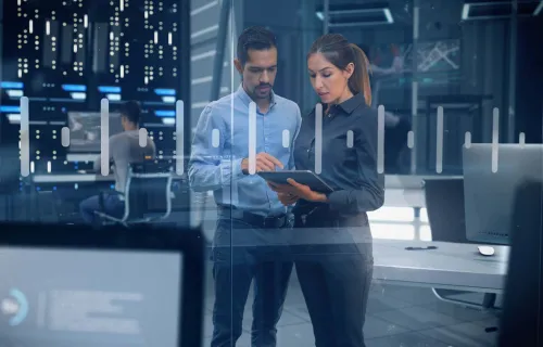 engineers analyzing data on touch screen in a data center