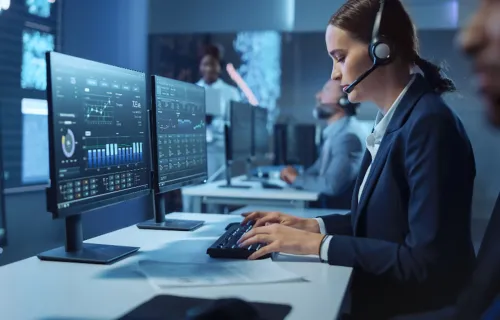 Defence consultant working at computer in control room
