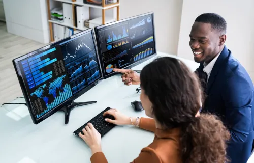 male and female colleagues reviewing graphs