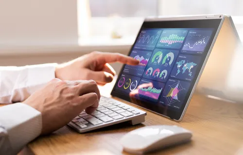 close up shot of someone’s hand using a dashboard on a touch screen device