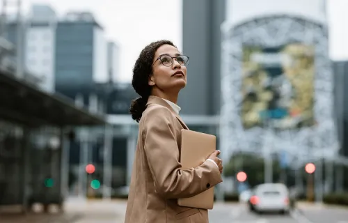 Professional looking up at a digital sign on a city street