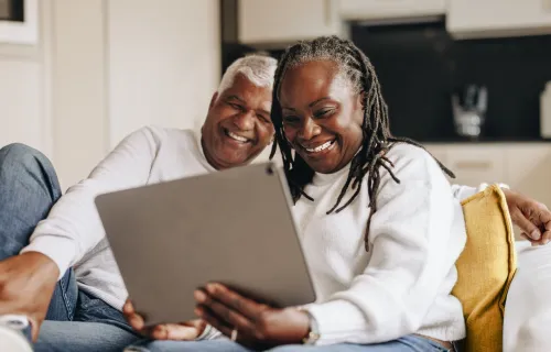Male and Female customers looking at digital screen