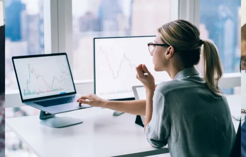 woman working on computer and laptop