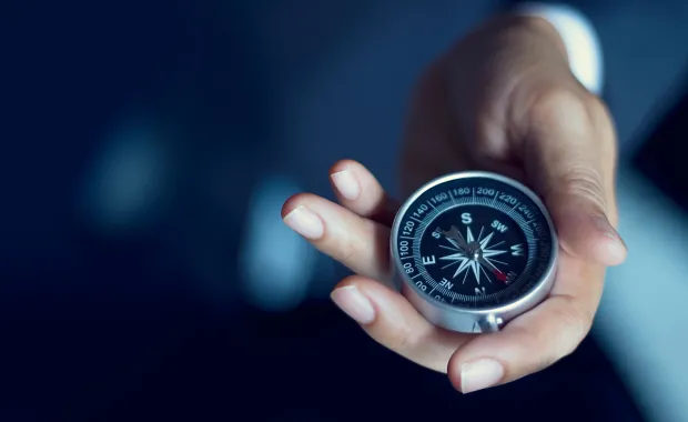 Compass being held in a hand