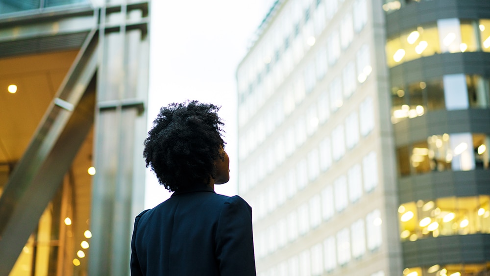 Explore our solutions person looking at a building